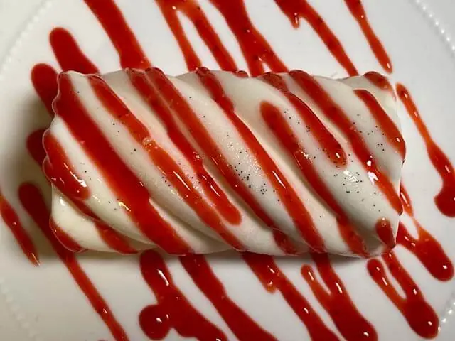 panna cotta senza glutine decorata con salsa di fragole